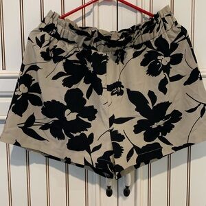 Beige Shorty shorts with a black teeth flower print size XL look great.